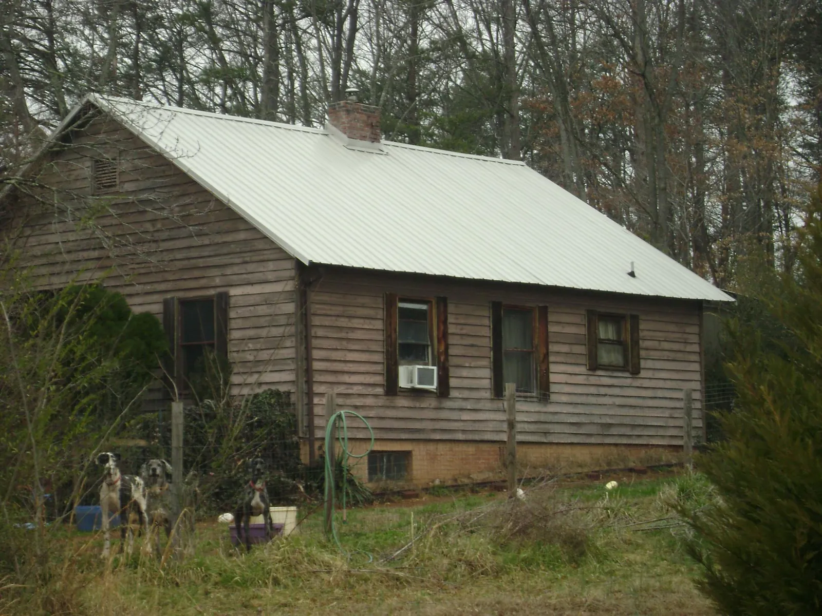 White metal roof on an old wood sided farmhouse, from a Metal Roof Installation job in Harpersville